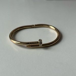 Gold nail bangle bracelet with diamonds on the head